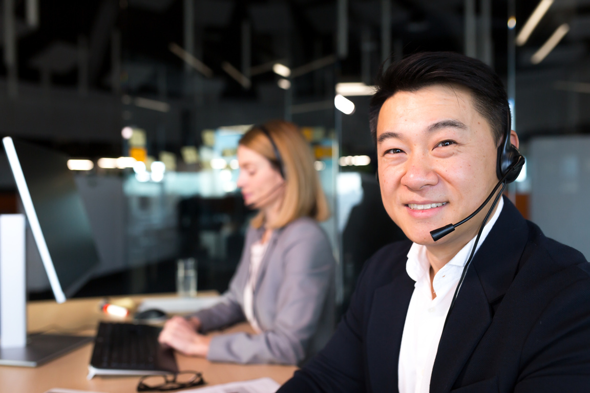Close-up photo, portrait of Asian male employee contact center